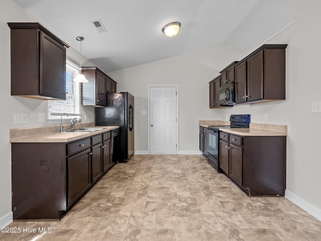 404 Bristol Ln, Hubert, NC 28539 - kitchen featuring black appliances, dark brown cabinetry, light countertops, lofted ceiling, and pendant lighting