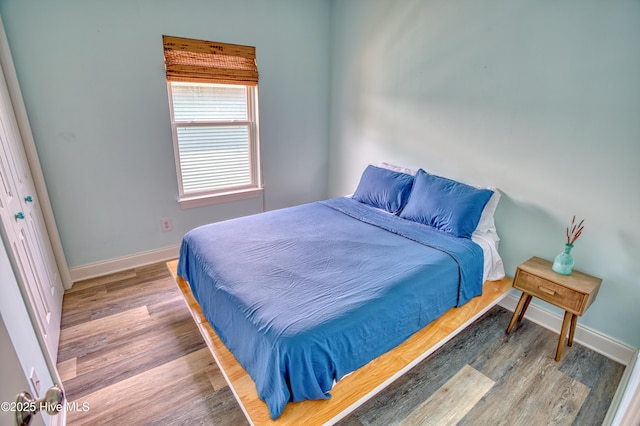 314 Spencer Farlow Dr Unit 2, Carolina Beach, NC 28428 - bedroom with baseboards and wood finished floors