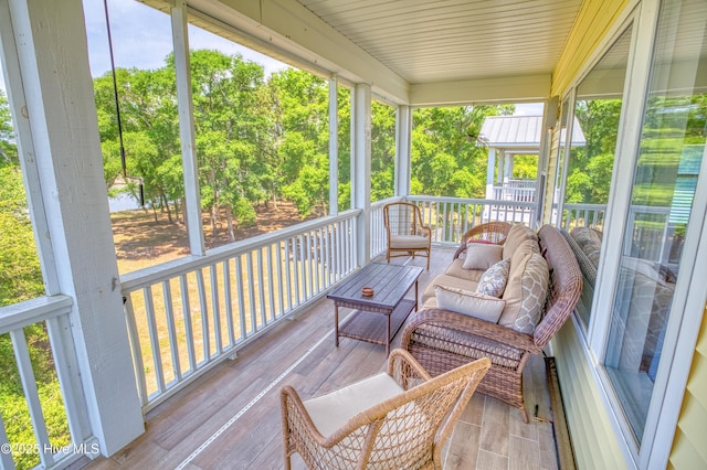 314 Spencer Farlow Dr Unit 2, Carolina Beach, NC 28428 - sunroom / solarium featuring an outdoor hangout area and view of scattered trees