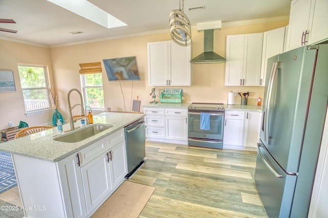 314 Spencer Farlow Dr Unit 2, Carolina Beach, NC 28428 - kitchen featuring appliances with stainless steel finishes, wall chimney range hood, white cabinetry, light stone counters, and ornamental molding