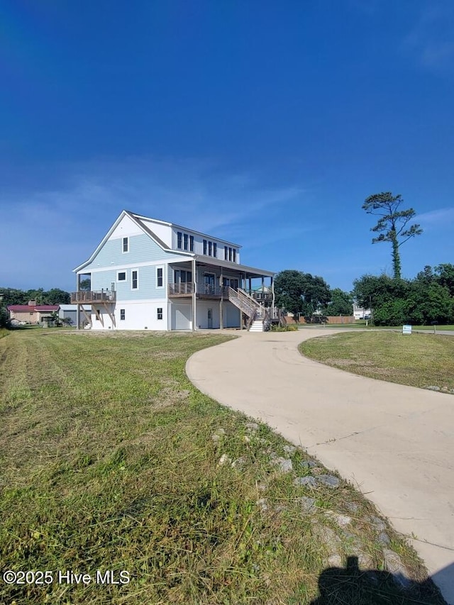202 Topsail Watch Dr, Hampstead, NC 28443 - view of front of home featuring driveway, a front lawn, and stairs