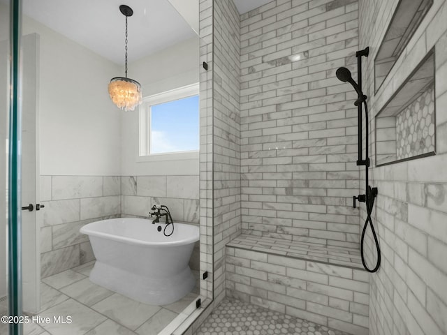 202 Topsail Watch Dr, Hampstead, NC 28443 - bathroom with a freestanding tub, a tile shower, and tile walls