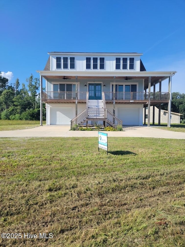 202 Topsail Watch Dr, Hampstead, NC 28443 - beach home with an attached garage, stairway, a ceiling fan, and driveway