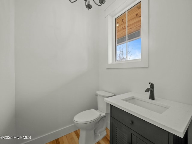 202 Topsail Watch Dr, Hampstead, NC 28443 - half bath featuring wood finished floors, vanity, and a chandelier