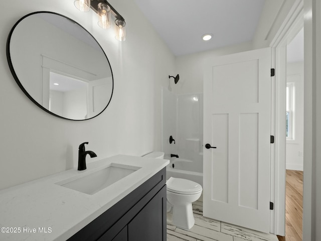 202 Topsail Watch Dr, Hampstead, NC 28443 - bathroom with vanity, washtub / shower combination, and wood finished floors