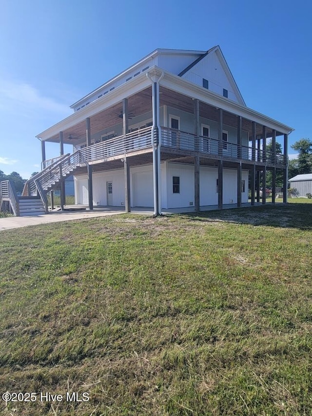 202 Topsail Watch Dr, Hampstead, NC 28443 - back of house with a yard, a ceiling fan, and stairs
