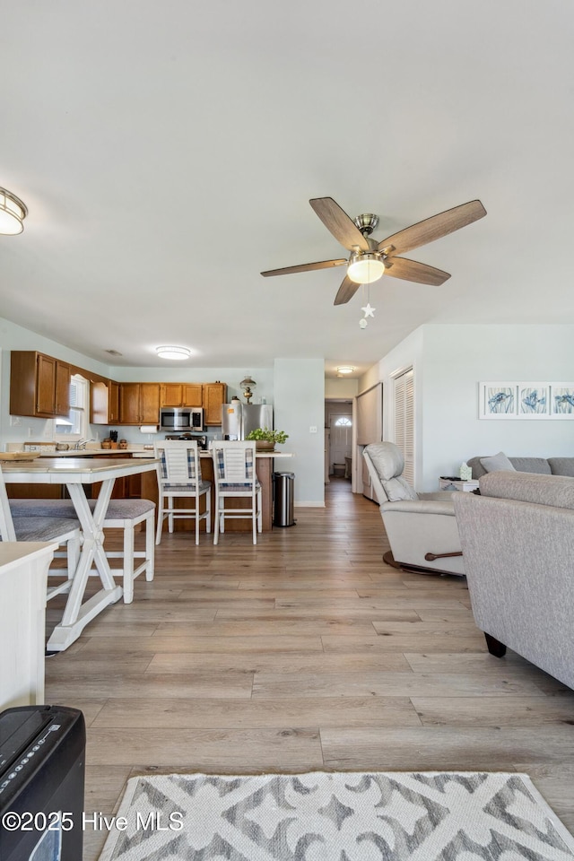9010 W 9th St, Surf City, NC 28445 - living room with light wood-style flooring and ceiling fan