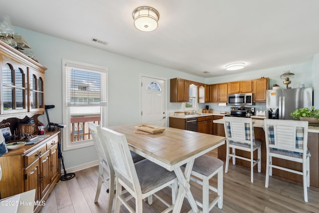 9010 W 9th St, Surf City, NC 28445 - dining room with light wood-style floors and baseboards