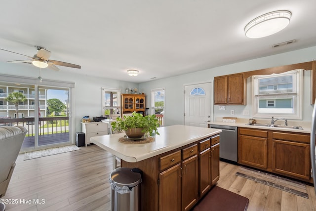 9010 W 9th St, Surf City, NC 28445 - kitchen with stainless steel dishwasher, light countertops, ceiling fan, light wood-type flooring, and a kitchen island