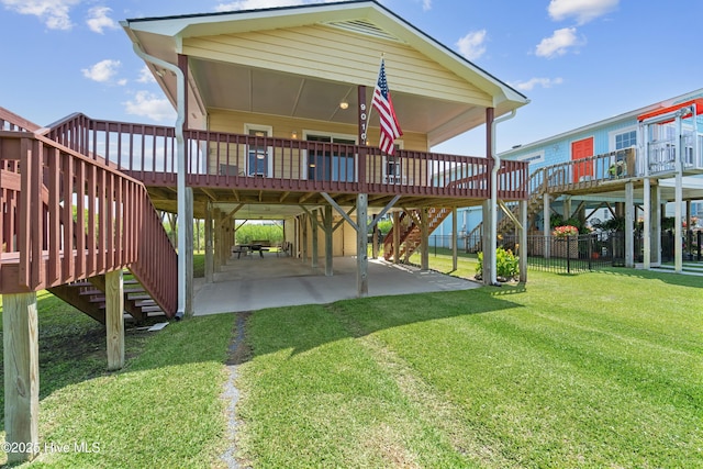 9010 W 9th St, Surf City, NC 28445 - back of property with stairway, a carport, a patio area, and a wooden deck