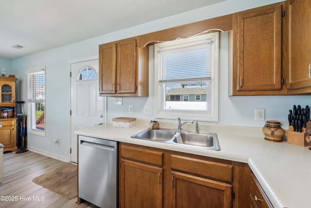 9010 W 9th St, Surf City, NC 28445 - kitchen featuring dishwasher, light countertops, brown cabinets, and light wood-style flooring