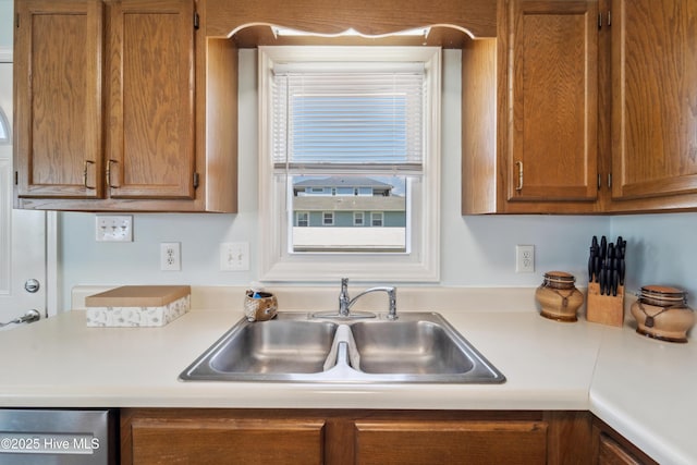 9010 W 9th St, Surf City, NC 28445 - kitchen featuring brown cabinetry, light countertops, and dishwasher