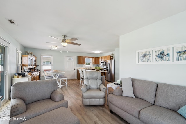 9010 W 9th St, Surf City, NC 28445 - living area featuring light wood-style flooring and ceiling fan