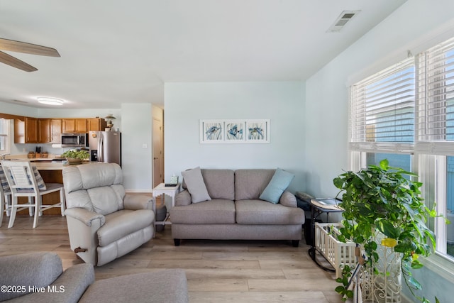 9010 W 9th St, Surf City, NC 28445 - living room with light wood finished floors and ceiling fan