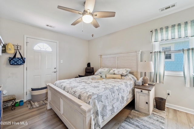 9010 W 9th St, Surf City, NC 28445 - bedroom with multiple windows, light wood-type flooring, and ceiling fan