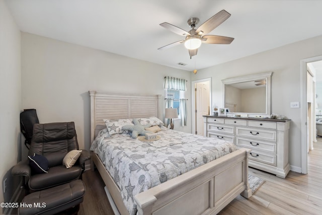 9010 W 9th St, Surf City, NC 28445 - bedroom featuring light wood-style flooring and a ceiling fan