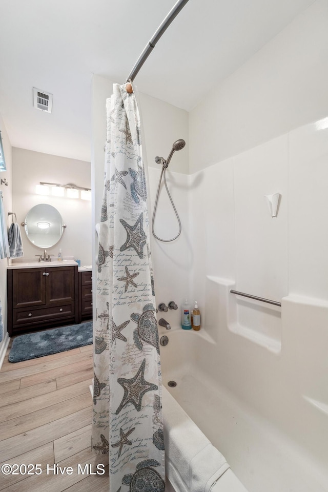 9010 W 9th St, Surf City, NC 28445 - full bath with wood finished floors, vanity, and shower / tub combo