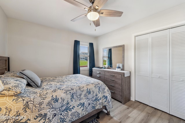 9010 W 9th St, Surf City, NC 28445 - bedroom with light wood finished floors, a closet, and ceiling fan