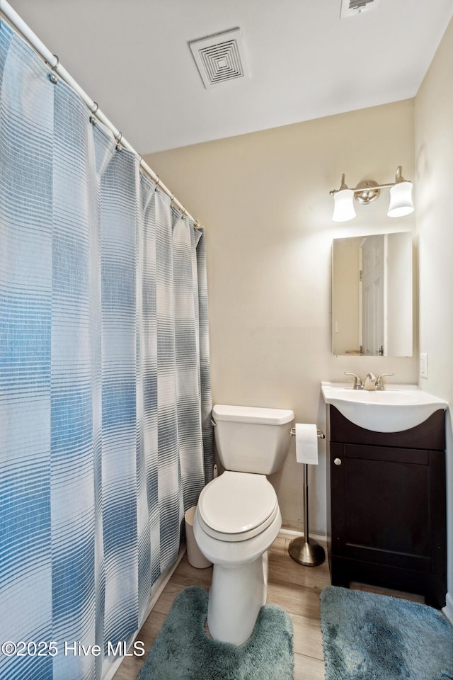 9010 W 9th St, Surf City, NC 28445 - bathroom with vanity, wood finished floors, and a shower with curtain