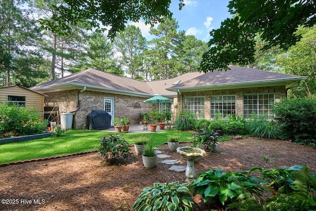 1 Pine Crest Dr, Whispering Pines, NC 28327 - back of property featuring a yard, a patio, brick siding, and a shingled roof