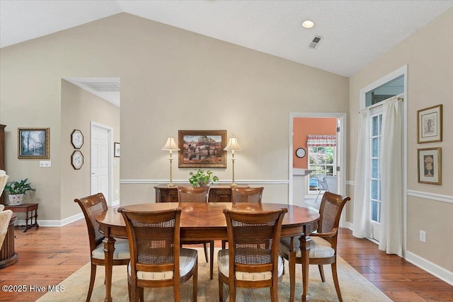 1 Pine Crest Dr, Whispering Pines, NC 28327 - dining area with hardwood / wood-style flooring and high vaulted ceiling