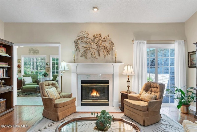 1 Pine Crest Dr, Whispering Pines, NC 28327 - living room with wood finished floors, a high end fireplace, and a textured ceiling