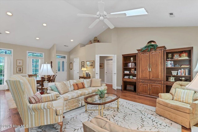 1 Pine Crest Dr, Whispering Pines, NC 28327 - living area featuring light wood-style floors, a ceiling fan, recessed lighting, high vaulted ceiling, and a skylight