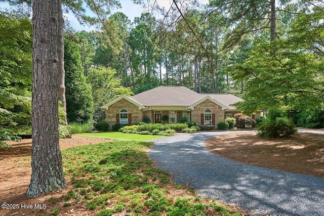 1 Pine Crest Dr, Whispering Pines, NC 28327 - single story home with curved driveway and brick siding
