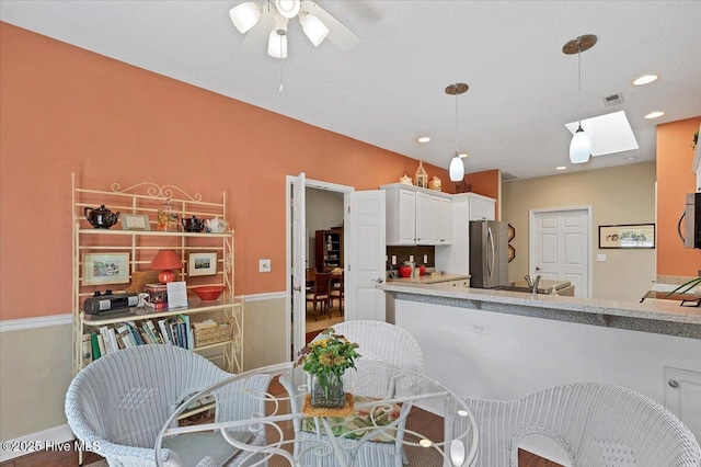 1 Pine Crest Dr, Whispering Pines, NC 28327 - kitchen featuring appliances with stainless steel finishes, ceiling fan, pendant lighting, white cabinetry, and light countertops