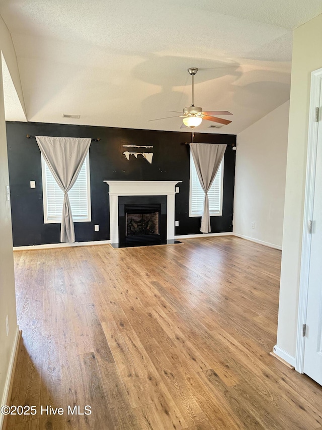 102 Harmony Way, Richlands, NC 28574 - unfurnished living room featuring wood finished floors, ceiling fan, and a fireplace