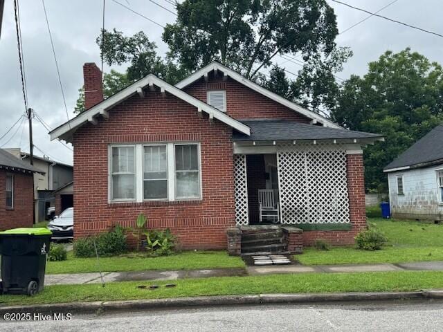 111 S Dr Martin Luther King Jr Dr S, Ahoskie, NC 27910 - bungalow-style house with a chimney, brick siding, and a front lawn