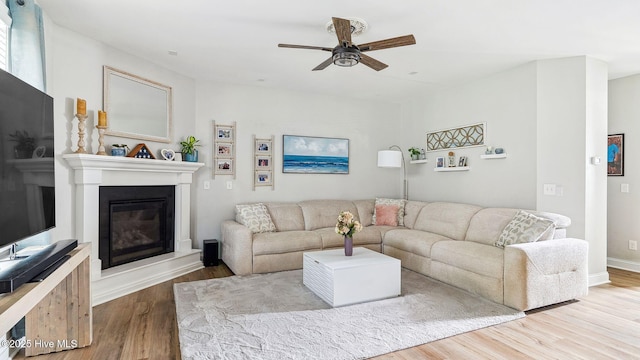 75 Bynum Ct, Vass, NC 28394 - living area with a glass covered fireplace, wood finished floors, and a ceiling fan