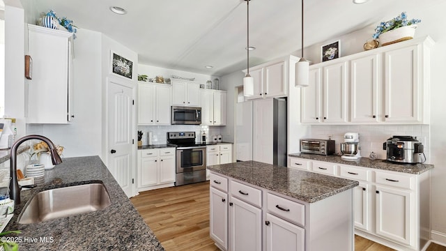 75 Bynum Ct, Vass, NC 28394 - kitchen with appliances with stainless steel finishes, decorative backsplash, white cabinets, light wood-style floors, and recessed lighting
