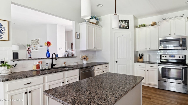75 Bynum Ct, Vass, NC 28394 - kitchen with stainless steel appliances, backsplash, white cabinets, and a center island