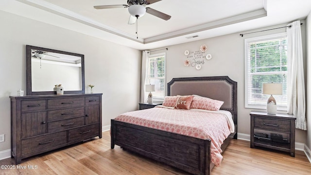 75 Bynum Ct, Vass, NC 28394 - bedroom featuring a raised ceiling, light wood-style flooring, multiple windows, and crown molding