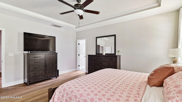 75 Bynum Ct, Vass, NC 28394 - bedroom featuring a tray ceiling, light wood-type flooring, crown molding, and a ceiling fan