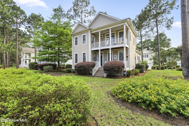 1178 Eastwood Landing Way, Sunset Beach, NC 28468 - neoclassical / greek revival house with a balcony and a front yard