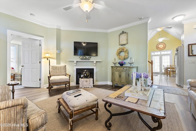 1178 Eastwood Landing Way, Sunset Beach, NC 28468 - living room with ceiling fan, healthy amount of natural light, a fireplace, crown molding, and wood finished floors
