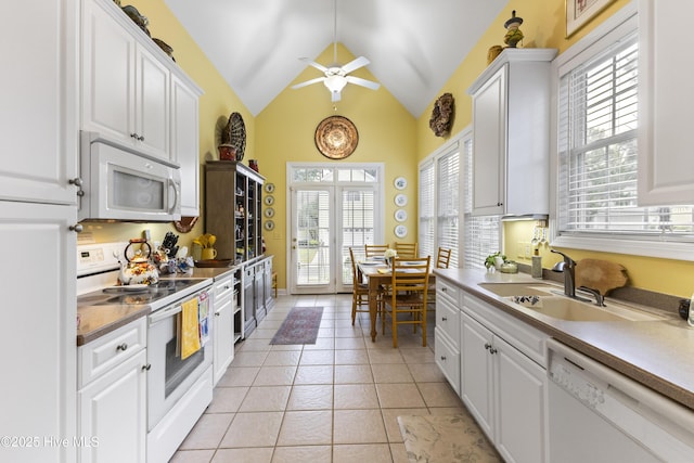 1178 Eastwood Landing Way, Sunset Beach, NC 28468 - kitchen featuring white appliances, white cabinetry, a ceiling fan, light tile patterned flooring, and vaulted ceiling