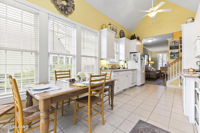 1178 Eastwood Landing Way, Sunset Beach, NC 28468 - dining room featuring a ceiling fan, vaulted ceiling, and light tile patterned flooring