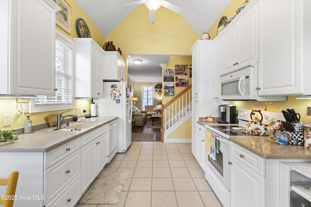 1178 Eastwood Landing Way, Sunset Beach, NC 28468 - kitchen with white appliances, white cabinets, lofted ceiling, a ceiling fan, and light tile patterned floors