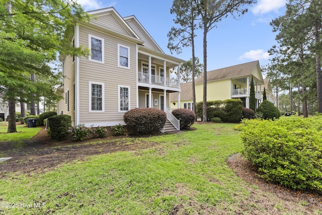 1178 Eastwood Landing Way, Sunset Beach, NC 28468 - view of front of home featuring a front lawn and a balcony