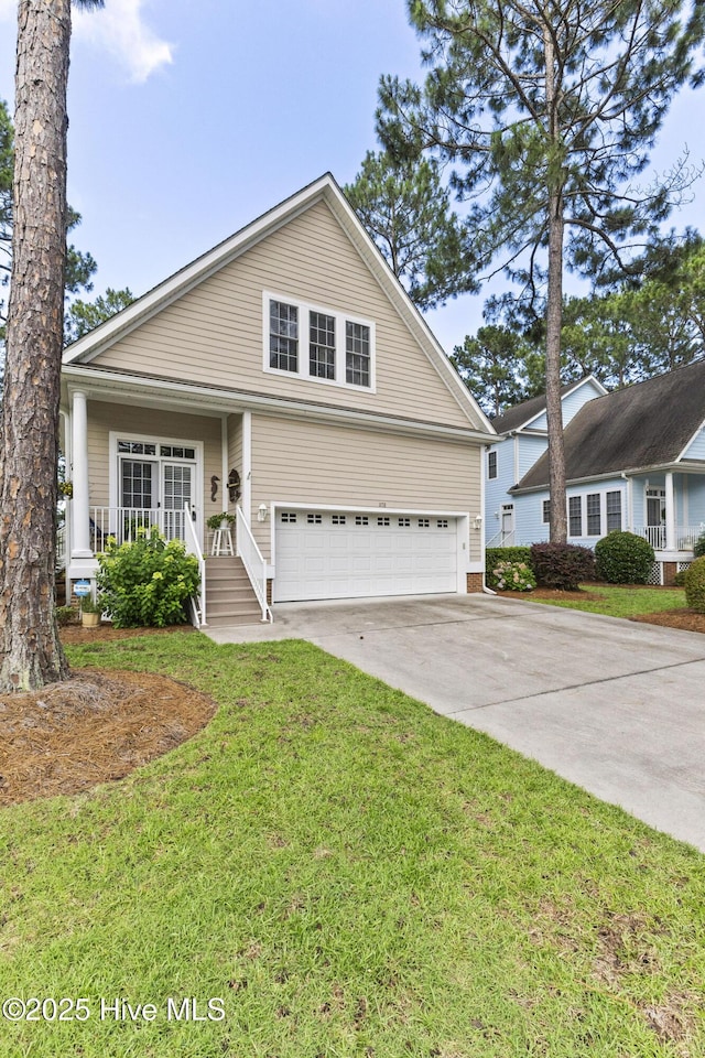 1178 Eastwood Landing Way, Sunset Beach, NC 28468 - traditional home featuring an attached garage, driveway, a front lawn, and covered porch