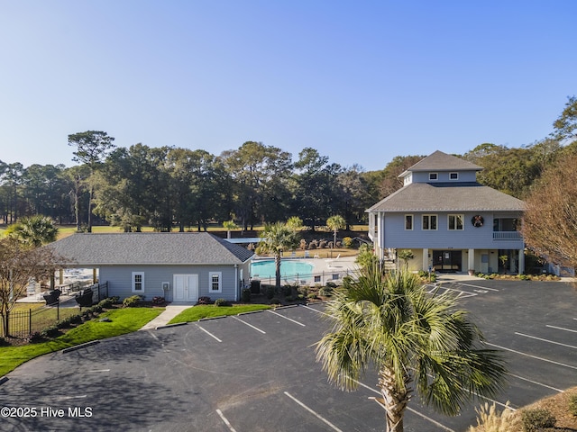 1178 Eastwood Landing Way, Sunset Beach, NC 28468 - uncovered parking lot featuring a community pool