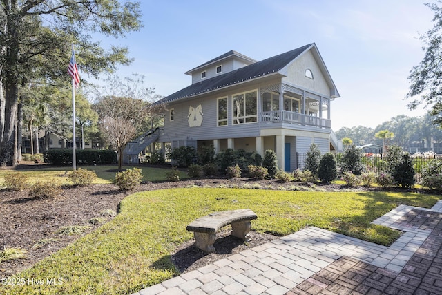 1178 Eastwood Landing Way, Sunset Beach, NC 28468 - view of front of home with a front yard, a metal roof, and a balcony