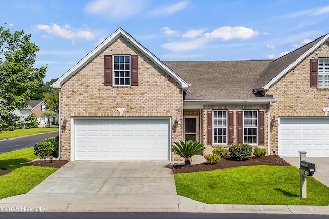 73 Field Planters Cir, Calabash, NC 28467 - traditional home featuring concrete driveway, roof with shingles, a garage, brick siding, and a front lawn