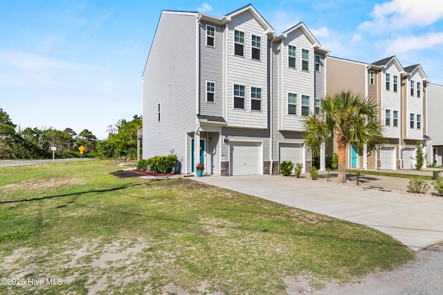 701 Elton Ave Unit 1, Carolina Beach, NC 28428 - view of property featuring driveway, a garage, and a front lawn