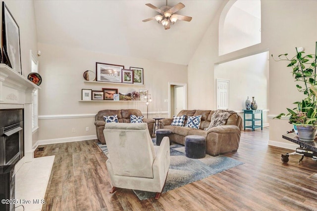 419 Morgan Trace Ln, Goldsboro, NC 27530 - living room featuring high vaulted ceiling, a fireplace with flush hearth, a ceiling fan, and wood finished floors