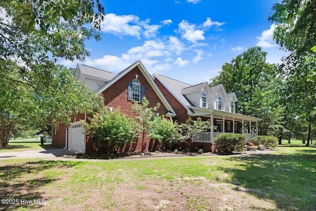 419 Morgan Trace Ln, Goldsboro, NC 27530 - view of front of property featuring concrete driveway, a front yard, brick siding, covered porch, and a garage