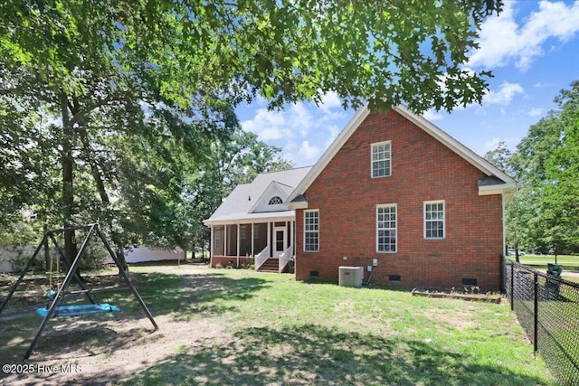 419 Morgan Trace Ln, Goldsboro, NC 27530 - rear view of property with crawl space, a sunroom, a fenced backyard, brick siding, and a playground